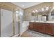 Bright bathroom with a double vanity, large mirror, separate shower, and soaking tub at 8761 W Mary Ann Dr, Peoria, AZ 85382