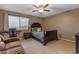 Comfortable bedroom with a large window and a dark wood bed frame at 8761 W Mary Ann Dr, Peoria, AZ 85382