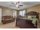 Bedroom featuring a large bed, couch, window views, and neutral color palette at 8761 W Mary Ann Dr, Peoria, AZ 85382