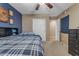 Bedroom featuring a bed with plaid bedding and a white closet at 8761 W Mary Ann Dr, Peoria, AZ 85382