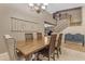 Dining area with a rustic wood table, seating for six, and an open view of the staircase at 8761 W Mary Ann Dr, Peoria, AZ 85382