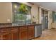 Charming kitchen features granite countertops, stainless steel appliances, and a plant near a window at 8761 W Mary Ann Dr, Peoria, AZ 85382
