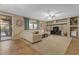 Bright living room with a sectional sofa, media console, and access to the outdoor area at 8761 W Mary Ann Dr, Peoria, AZ 85382
