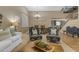 Inviting living area showcasing neutral decor, an open staircase, and an adjoining dining room at 8761 W Mary Ann Dr, Peoria, AZ 85382