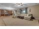 Spacious living room with comfortable sectional sofa, ceiling fan, and views to the kitchen at 8761 W Mary Ann Dr, Peoria, AZ 85382