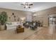 Comfortable living room featuring neutral decor, large windows, and an open floor plan at 8761 W Mary Ann Dr, Peoria, AZ 85382