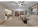 Open-concept living room with kitchen and staircase, perfect for modern living and entertaining at 8761 W Mary Ann Dr, Peoria, AZ 85382