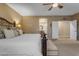 Tranquil bedroom with plush bed, bench, and open access to the en-suite bathroom at 8761 W Mary Ann Dr, Peoria, AZ 85382