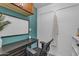 Well lit office space, featuring a desk, whiteboard, chair, closet, and upper cabinets for organized workspace at 8761 W Mary Ann Dr, Peoria, AZ 85382