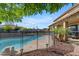 Refreshing pool with safety fence, complemented by lush greenery and a cozy covered patio area at 8761 W Mary Ann Dr, Peoria, AZ 85382