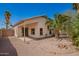 Charming backyard with desert landscaping, a patio, and views of the home's exterior creates the perfect backdrop at 9922 E Onza Ave, Mesa, AZ 85212