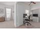 Versatile bedroom space featuring a ceiling fan and dedicated area for home office setup at 9922 E Onza Ave, Mesa, AZ 85212