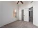 Cozy bedroom featuring plush carpeting, a ceiling fan, and a closet with sliding doors for ample storage at 9922 E Onza Ave, Mesa, AZ 85212
