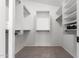 Walk-in closet with neutral carpet, custom shelving and hanging racks to maximize storage and organization at 9922 E Onza Ave, Mesa, AZ 85212