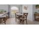Bright dining area features a charming window and stylish decor with a wooden dining table and chairs at 9922 E Onza Ave, Mesa, AZ 85212