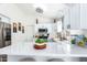 Bright kitchen with white cabinetry, stainless steel appliances, and a white countertop island at 9922 E Onza Ave, Mesa, AZ 85212