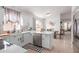 Bright, remodeled kitchen with stainless steel appliances, white cabinets and adjacent dining space at 9922 E Onza Ave, Mesa, AZ 85212