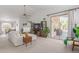 Bright living room featuring high ceilings, comfortable seating, and a sliding glass door to the patio at 9922 E Onza Ave, Mesa, AZ 85212