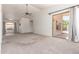 Spacious living room with vaulted ceilings, a ceiling fan, and sliding glass doors to the patio at 9922 E Onza Ave, Mesa, AZ 85212