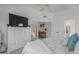 Spacious primary bedroom with light walls, carpet floors, white dresser, and bed with leafy patterned linens at 9922 E Onza Ave, Mesa, AZ 85212