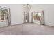 Bright main bedroom with neutral carpet, three windows, and generous space for relaxation at 9922 E Onza Ave, Mesa, AZ 85212