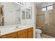 Well-lit bathroom with a tiled walk-in shower and vanity storage at 10401 N Saguaro Blvd # 130, Fountain Hills, AZ 85268