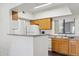 Charming kitchen features wood cabinets, white appliances, and an open breakfast bar at 10401 N Saguaro Blvd # 130, Fountain Hills, AZ 85268