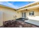 Exterior of the back patio features a ceiling fan, greenery, and an access door at 10909 W Santa Fe Dr, Sun City, AZ 85351