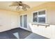 Enclosed back patio features a ceiling fan, and access to a garden area at 10909 W Santa Fe Dr, Sun City, AZ 85351