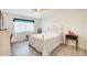 Cozy bedroom with a white wrought iron bed frame, soft lighting, and neutral decor at 10909 W Santa Fe Dr, Sun City, AZ 85351