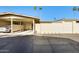 Exterior view showcasing a single-story house with a carport and drought-resistant landscaping at 10909 W Santa Fe Dr, Sun City, AZ 85351