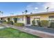 Charming home featuring a well-manicured lawn and lovely exterior details at 10909 W Santa Fe Dr, Sun City, AZ 85351