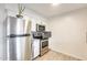 Well-equipped kitchen featuring stainless steel appliances, white cabinetry, and tiled backsplash at 10909 W Santa Fe Dr, Sun City, AZ 85351