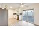Bright kitchen with a stainless steel dishwasher, sink, white cabinets, and access to a patio at 10909 W Santa Fe Dr, Sun City, AZ 85351