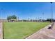 This is the lawn bowling area, with benches and shade cover, providing a relaxing outdoor activity at 10909 W Santa Fe Dr, Sun City, AZ 85351