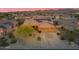 Stunning aerial view of desert home with solar panels, xeriscaping, and mountain views at 10931 S Santa Columbia Dr, Goodyear, AZ 85338