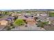 Attractive aerial view of a home with solar panels, desert landscaping, mountain and lake views at 10931 S Santa Columbia Dr, Goodyear, AZ 85338