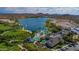 Beautiful aerial view of community pool, lake, and palm trees, perfect for relaxation at 10931 S Santa Columbia Dr, Goodyear, AZ 85338