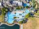 Aerial view of a resort-style pool with slide, lap pool, and lush landscaping at 10931 S Santa Columbia Dr, Goodyear, AZ 85338