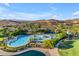 Aerial view of resort-style community pool with palm trees and lounge chairs at 10931 S Santa Columbia Dr, Goodyear, AZ 85338