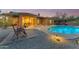 Lovely backyard featuring covered patio, heated pool, and lounge area perfect for outdoor entertainment at 10931 S Santa Columbia Dr, Goodyear, AZ 85338