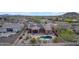 A high-angle view of a house with solar panels, a pool and patio surrounded by desert landscaping at 10931 S Santa Columbia Dr, Goodyear, AZ 85338