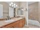 Bathroom features double sinks, stone countertops, wood cabinets and tile floors at 10931 S Santa Columbia Dr, Goodyear, AZ 85338