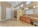 Spacious bathroom featuring a walk-in glass block shower and marble countertop vanity at 10931 S Santa Columbia Dr, Goodyear, AZ 85338