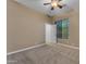 Neutral bedroom features carpet, ceiling fan and window with blinds at 10931 S Santa Columbia Dr, Goodyear, AZ 85338