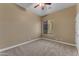 Neutral bedroom features carpet, ceiling fan and window with blinds at 10931 S Santa Columbia Dr, Goodyear, AZ 85338