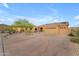 Spacious single-story home with a three-car garage, desert landscaping, and a large driveway at 10931 S Santa Columbia Dr, Goodyear, AZ 85338