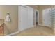 Hallway with tile floors, closet with sliding doors, and neutral color palette at 10931 S Santa Columbia Dr, Goodyear, AZ 85338