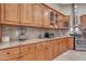 Close-up of a kitchen featuring wood cabinets, granite countertops, and stainless steel appliances at 10931 S Santa Columbia Dr, Goodyear, AZ 85338