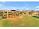 Community playground with covered play structure and ample green space for outdoor activities and Gathering fun at 10931 S Santa Columbia Dr, Goodyear, AZ 85338